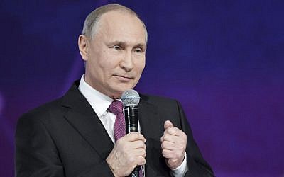 Russian President Vladimir Putin speaks at the annual Volunteer of Russia 2017 award ceremony at the Megasport Sport Palace in Moscow, Russia, December 6, 2017. (Alexei Nikolsky, Sputnik, Kremlin Pool Photo via AP)