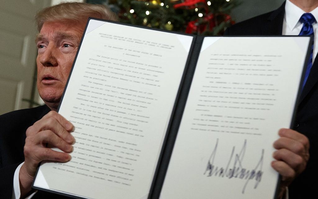 US President Donald Trump holds up a proclamation to officially recognize Jerusalem as the capital of Israel, in the Diplomatic Reception Room of the White House, on Dec. 6, 2017. (AP Photo/Evan Vucci) US President Donald Trump holds up a proclamation to officially recognize Jerusalem as the capital of Israel, in the Diplomatic Reception Room of the White House, on Dec. 6, 2017. (AP Photo/Evan Vucci)