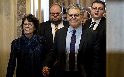 Senator Al Franken, D-Minn., second from right, holds hands with his wife Franni Bryson, left, as he leaves the Capitol after speaking on the Senate floor, December 7, 2017, on Capitol Hill in Washington. (AP Photo/Andrew Harnik)