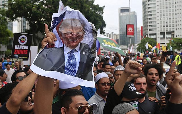 Muslims crumple a portrait of US President Donald Trump during a protest outside the US Embassy in Kuala Lumpur, Malaysia, December 8, 2017. (AP Photo/Sadiq Asyraf) Muslims crumple a portrait of US President Donald Trump during a protest outside the US Embassy in Kuala Lumpur, Malaysia, December 8, 2017. (AP Photo/Sadiq Asyraf)