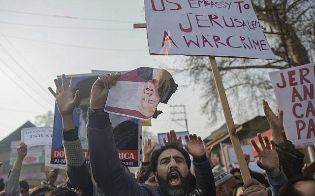 A Kashmiri Muslim shouts slogans and holds a burning photograph of US President Donald Trump during a protest against a decision to recognize Jerusalem as Israel's capital, held in Budgam, southwest of Srinagar, Indian-controlled Kashmir, December 8, 2017. (Dar Yasin/AP) A Kashmiri Muslim shouts slogans and holds a burning photograph of US President Donald Trump during a protest against a decision to recognize Jerusalem as Israel's capital, held in Budgam, southwest of Srinagar, Indian-controlled Kashmir, December 8, 2017. (Dar Yasin/AP)