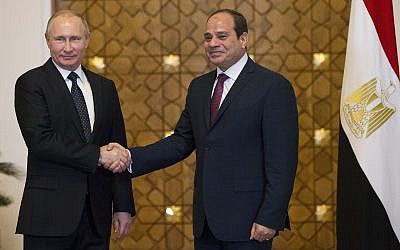Russian President Vladimir Putin, left, and Egyptian President Abdel-Fattah El-Sissi, shake hands during their meeting in Cairo, Egypt, December 11, 2017. (Alexander Zemlianichenko/ pool photo via AP)