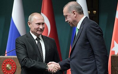 Russia's President Vladimir Putin, left, and Turkey's President Recep Tayyip Erdogan shake hands after a press conference during their meeting in Ankara, Turkey, December 11, 2017. (Alexei Druzhinin/Pool Photo via AP)