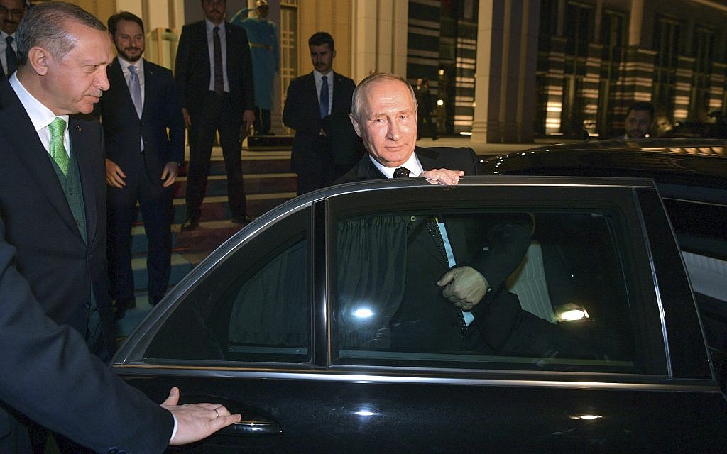 Turkey's President Recep Tayyip Erdogan, left, escorts Russia's President Vladimir Putin, right, as he leaves their meeting at the Presidential Palace in Ankara, December 11, 2017. (Alexei Druzhinin, Sputnik, Kremlin Pool Photo via AP)
