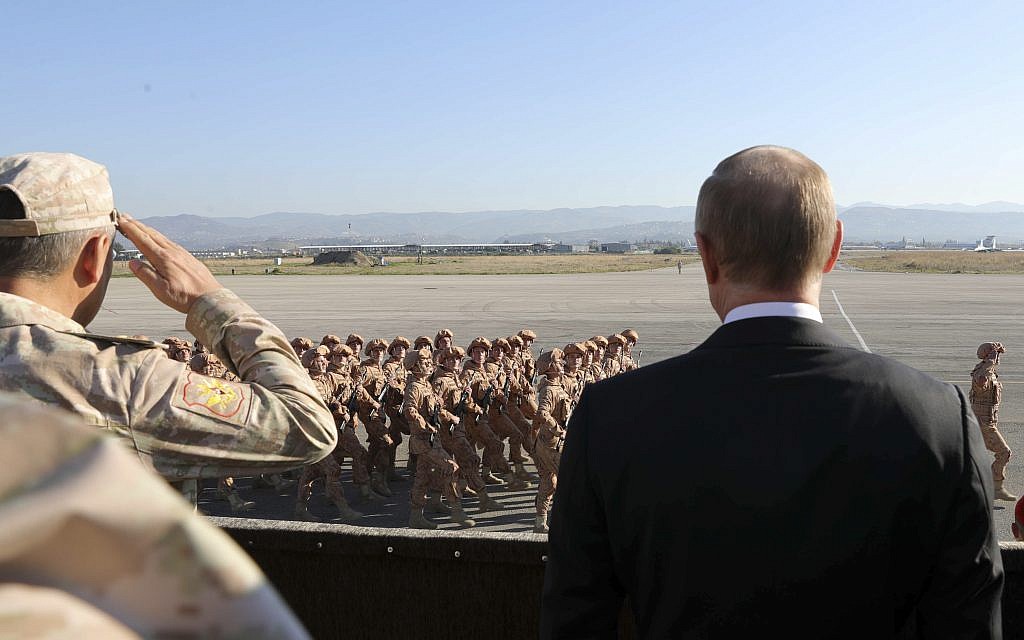 Russian President Vladimir Putin, right, meets troops alongside Syrian President Bashar Assad on a visit to the Hmeimim air base in Syria, December 11, 2017. (Mikhail Klimentyev, Sputnik, Kremlin Pool Photo via AP)
