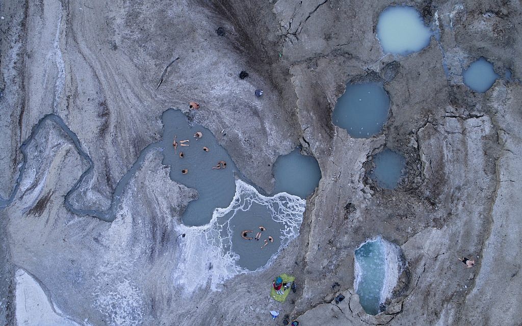 In this December 8, 2017, photo, people enjoy a spring water pool along the Dead Sea shore near the Israeli kibbutz of Ein Gedi. (AP Photo/Oded Balilty)