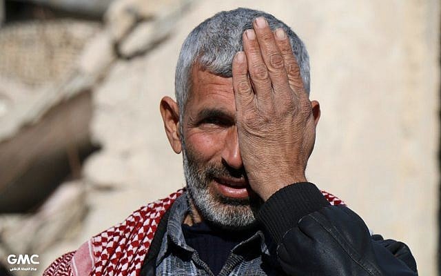 This photo provided on Monday, Dec. 18, 2017 by the Syrian anti-government activist group Ghouta Media Center, which has been authenticated based on its contents and other AP reporting, shows a man in Eastern Ghouta, a rebel-held suburb near the Syrian capital Damascus, covering his left eye in solidarity with Karim, who was injured weeks ago in a government bombing of the market of his hometown. Karim lost his mother and one eye in the bombings and is now becoming the face of a solidarity campaign with Eastern Ghouta, which has been besieged for nearly five years. (Ghouta Media Center via AP) This photo provided on Monday, Dec. 18, 2017 by the Syrian anti-government activist group Ghouta Media Center, which has been authenticated based on its contents and other AP reporting, shows a man in Eastern Ghouta, a rebel-held suburb near the Syrian capital Damascus, covering his left eye in solidarity with Karim, who was injured weeks ago in a government bombing of the market of his hometown. Karim lost his mother and one eye in the bombings and is now becoming the face of a solidarity campaign with Eastern Ghouta, which has been besieged for nearly five years. (Ghouta Media Center via AP)