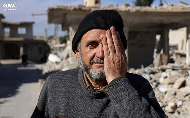 This photo provided on Monday, Dec. 18, 2017 by the Syrian anti-government activist group Ghouta Media Center, which has been authenticated based on its contents and other AP reporting, shows a man in Eastern Ghouta, a rebel-held suburb near the Syrian capital Damascus, covering his left eye in solidarity with Karim, who was injured weeks ago in a government bombing of the market of his hometown. Karim lost his mother and one eye in the bombings and is now becoming the face of a solidarity campaign with Eastern Ghouta, which has been besieged for nearly five years. (Ghouta Media Center via AP) This photo provided on Monday, Dec. 18, 2017 by the Syrian anti-government activist group Ghouta Media Center, which has been authenticated based on its contents and other AP reporting, shows a man in Eastern Ghouta, a rebel-held suburb near the Syrian capital Damascus, covering his left eye in solidarity with Karim, who was injured weeks ago in a government bombing of the market of his hometown. Karim lost his mother and one eye in the bombings and is now becoming the face of a solidarity campaign with Eastern Ghouta, which has been besieged for nearly five years. (Ghouta Media Center via AP)