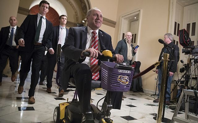 House Majority Whip Steve Scalise, a Republican of Louisiana, rides his scooter to the chamber for the final vote on the GOP tax bill, at the Capitol in Washington, December 19, 2017. (AP Photo/J. Scott Applewhite) House Majority Whip Steve Scalise, a Republican of Louisiana, rides his scooter to the chamber for the final vote on the GOP tax bill, at the Capitol in Washington, December 19, 2017. (AP Photo/J. Scott Applewhite)