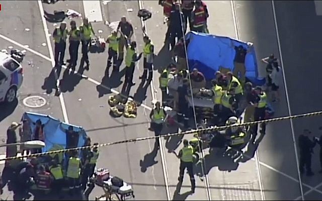 In this screenshot from a video from the Australian Broadcasting Corp., emergency medical workers offer aid to victims struck by a vehicle, December 21, 20217, in Melbourne, Australia. (Australian Broadcast Corp. via AP) In this screenshot from a video from the Australian Broadcasting Corp., emergency medical workers offer aid to victims struck by a vehicle, December 21, 20217, in Melbourne, Australia. (Australian Broadcast Corp. via AP)