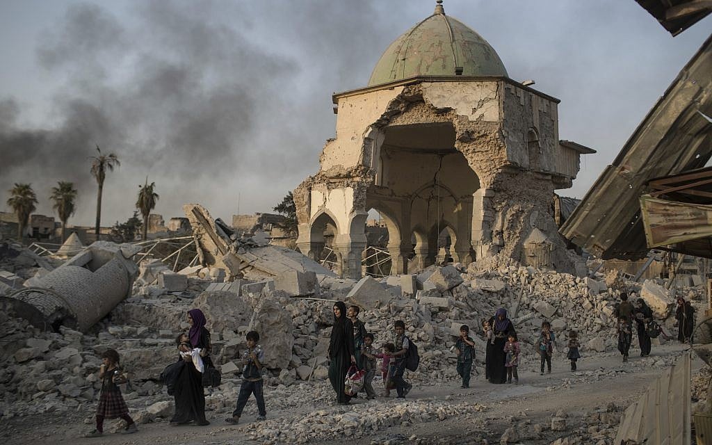 Iraqi civilians fleeing walk past the destroyed al-Nuri mosque as Iraqi forces continue their advance against Islamic State militants in the Old City of Mosul, Iraq, Tuesday, July 4, 2017. (AP Photo/Felipe Dana)