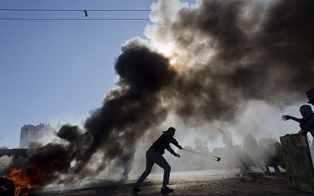 Illustrative. Palestinian protesters burn tires and clash with Israeli troops following protests against US President Donald Trump's decision to recognize Jerusalem as the capital of Israel, in the West Bank city of Ramallah, December 8, 2017. (AP Photo/Nasser Nasser) Illustrative. Palestinian protesters burn tires and clash with Israeli troops following protests against US President Donald Trump's decision to recognize Jerusalem as the capital of Israel, in the West Bank city of Ramallah, December 8, 2017. (AP Photo/Nasser Nasser)