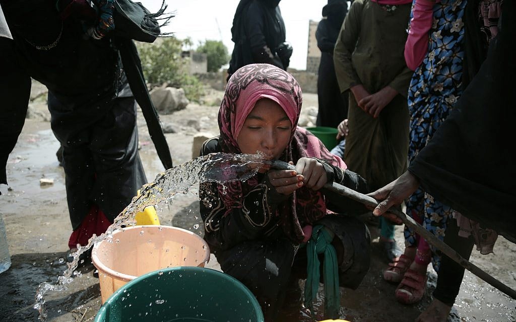 A girl drinks water from a well that alleged to be contaminated water with the bacterium Vibrio cholera, on the outskirts of Sanaa, Yemen on July 12, 2017. (AP Photo/Hani Mohammed)