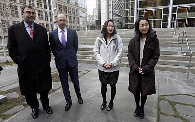 Mariko Hirose, right, a litigation director at the Urban Justice Center, Esther Sung, a staff attorney at the National Immigration Law Center, Rabbi Will Berkowitz, Jewish Family Service of Seattle CEO and Mark Hetfield, president and CEO of HIAS, stand in front of a federal courthouse after speaking with media members there Thursday, Dec. 21, 2017, in Seattle. (AP Photo/Elaine Thompson)
