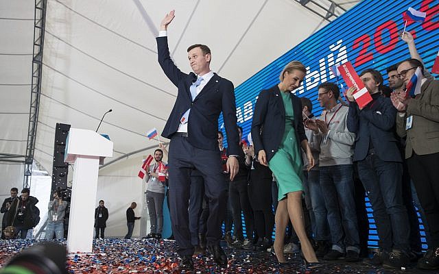 Russian opposition leader Alexei Navalny greets his supporters at a meeting that nominated him for the presidential election race in Moscow, Russia, December 24, 2017. (AP Photo/Pavel Golovkin) Russian opposition leader Alexei Navalny greets his supporters at a meeting that nominated him for the presidential election race in Moscow, Russia, December 24, 2017. (AP Photo/Pavel Golovkin)