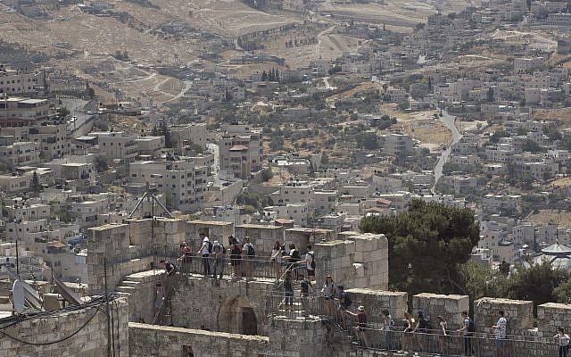 People tour the Jerusalem Ramparts Walk on Jerusalem's Old City walls overlooking the East Jerusalem neighborhood of Silwan, May 24, 2017. (AP Photo/Oded Balilty) People tour the Jerusalem Ramparts Walk on Jerusalem's Old City walls overlooking the East Jerusalem neighborhood of Silwan, May 24, 2017. (AP Photo/Oded Balilty)