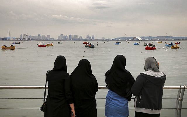 In this photo taken on April 2, 2017, women watch people riding boats on the Persian Gulf Martyrs lake, west of Tehran, Iran. (AP Photo/Ebrahim Noroozi) In this photo taken on April 2, 2017, women watch people riding boats on the Persian Gulf Martyrs lake, west of Tehran, Iran. (AP Photo/Ebrahim Noroozi)