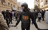 A policeman stands guard in front of Mar Mina church, in Helwan, Cairo, Egypt, Friday, Dec. 29, 2017 (AP Photo/Amr Nabil)
