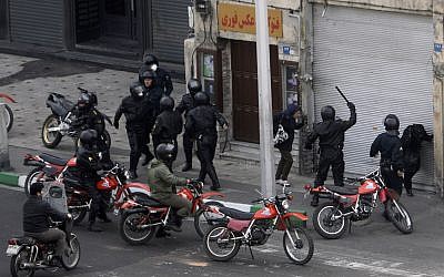 Iranian anti-riot police officers confronting people during an anti-government protest in Tehran, Iran, Sunday, Dec. 27, 2009. (AP)