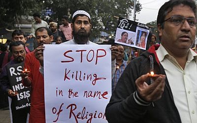 Human rights activists walk during a protest against the reported brutal killing of a Muslim laborer in the Indian western Rajasthan state, India, December 8, 2017. (AP Photo/Bikas Das)