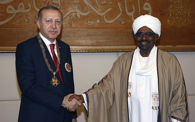 Sudan's President Omar al-Bashir, right, and Turkey's President Recep Tayyip Erdogan shake hands after al-Bashir presented Turkish leader with his country's highest medal during a ceremony in Khartoum, Sudan, Sunday, Dec. 24, 2017.(Kayhan Ozer/Pool Photo via AP) Sudan's President Omar al-Bashir, right, and Turkey's President Recep Tayyip Erdogan shake hands after al-Bashir presented Turkish leader with his country's highest medal during a ceremony in Khartoum, Sudan, Sunday, Dec. 24, 2017.(Kayhan Ozer/Pool Photo via AP)