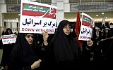 Iranian pro-regime protesters hold anti-Israeli placards at a rally in Tehran, Iran, Saturday, December 30, 2017 (AP Photo/Ebrahim Noroozi)