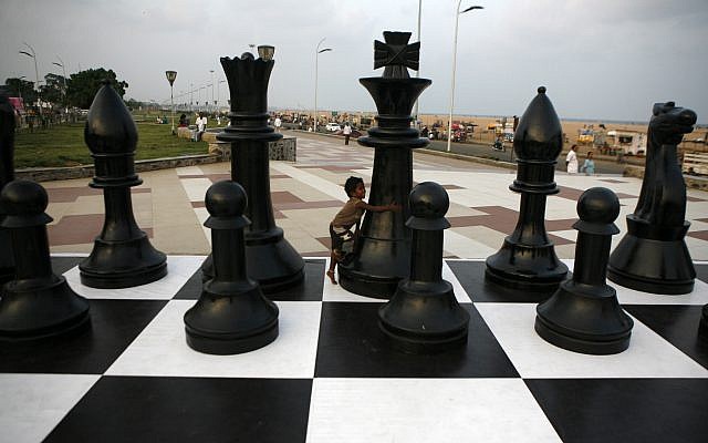 An Indian child plays around a huge chessboard model erected to mark the FIDE World Chess Championship at the Marina beach on the Bay of Bengal coast in Chennai, India, Thursday, November 7, 2013. (AP/Arun Sankar K ) An Indian child plays around a huge chessboard model erected to mark the FIDE World Chess Championship at the Marina beach on the Bay of Bengal coast in Chennai, India, Thursday, November 7, 2013. (AP/Arun Sankar K )