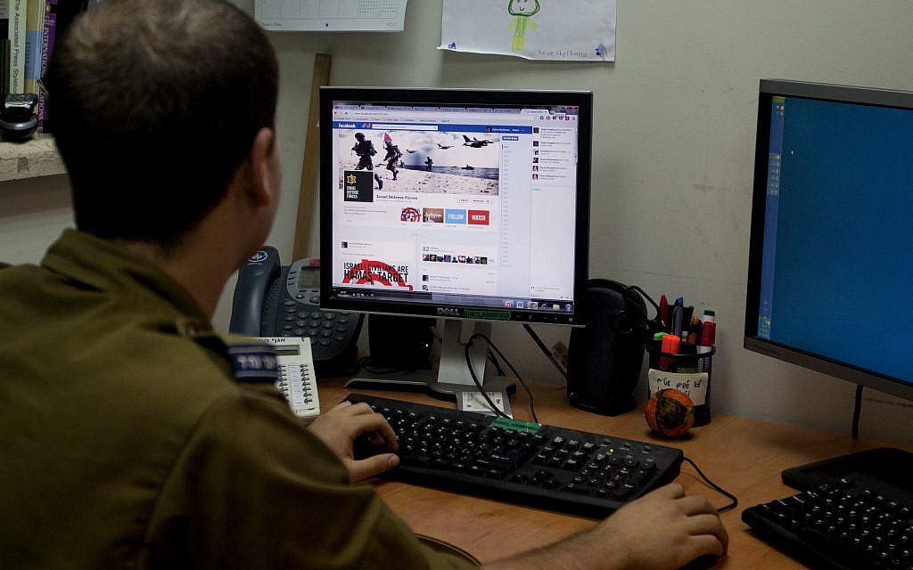 Illustrative: A soldier looks at the IDF's Facebook page at the army spokesperson's office in Jerusalem in November 2012. (photo credit: AP/Sebastian Scheiner) Illustrative: A soldier looks at the IDF's Facebook page at the army spokesperson's office in Jerusalem in November 2012. (photo credit: AP/Sebastian Scheiner)