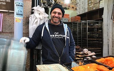 Uzi Sharabi selling baked goods at the Mahane Yehuda market in Jerusalem, Dec. 6, 2017. (Andrew Tobin)
