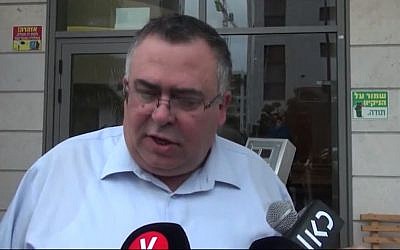 Coalition chair David Bitan leaves his home on his way to be questioned by police on suspicion of corruption, December 6, 2017. (Screen capture: Ynet)
