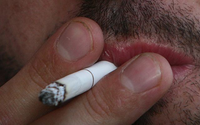 A man smokes a cigarette (Orel Cohen/ Flash90) A man smokes a cigarette (Orel Cohen/ Flash90)