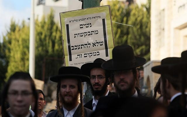 Ultra-Orthodox Jews stand in front of a sign in Beit Shemesh asking women not to loiter there on December 26, 2011. (Kobi Gideon/Flash90) Ultra-Orthodox Jews stand in front of a sign in Beit Shemesh asking women not to loiter there on December 26, 2011. (Kobi Gideon/Flash90)
