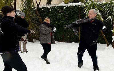 Prime Minister Benjamin Netanyahu has a snowball fight with his wife, Sara, and sons Avner and Yair at his residence in Jerusalem on January 10, 2013 (Avi Ohayon/GPO/FLASH90)