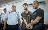 Omar al-Abed (center) is brought to the courtroom for his trial at the Ofer military court near the West Bank city of Ramallah on August 17, 2017. (Yonatan Sindel/Flash90)