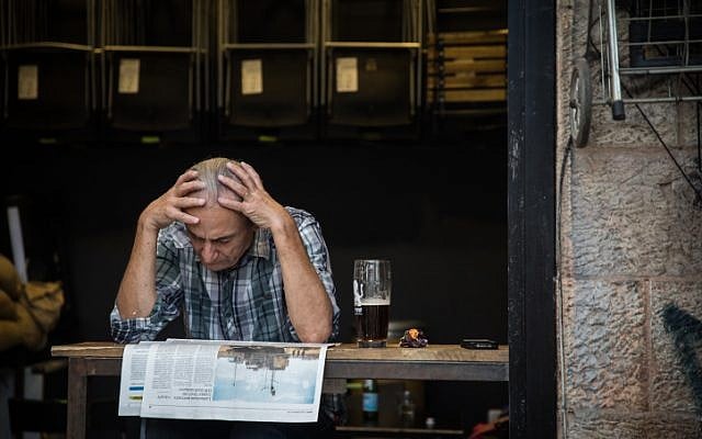 A man reads the newspaper at a cafe at the Mahane Yehuda Market in Jerusalem, on September 5, 2017. (Hadas Parush/Flash90) A man reads the newspaper at a cafe at the Mahane Yehuda Market in Jerusalem, on September 5, 2017. (Hadas Parush/Flash90)