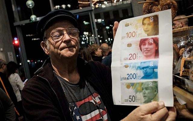A protester holds an image of the portraits of Likud lawmakers on Israel's currency during the anti-corruption 'march of shame' in Tel Aviv on December 2, 2017. (Tomer Neuberg/Flash90) A protester holds an image of the portraits of Likud lawmakers on Israel's currency during the anti-corruption 'march of shame' in Tel Aviv on December 2, 2017. (Tomer Neuberg/Flash90)