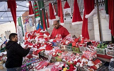 Christian Arabs sell Santa Claus hats and dolls in Nazareth ahead of Christmas on December 9, 2017. (Nati Shohat/Flash90)