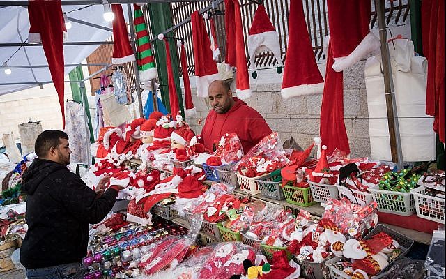 Christian Arabs sell Santa Claus hats and dolls in Nazareth ahead of Christmas on December 9, 2017. (Nati Shohat/Flash90) Christian Arabs sell Santa Claus hats and dolls in Nazareth ahead of Christmas on December 9, 2017. (Nati Shohat/Flash90)