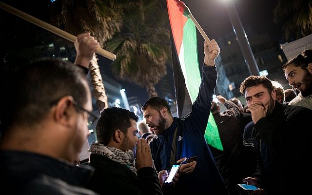 Arab Israelis take part in a protest outside the American embassy in Tel Aviv against US President Donald Trump's decision to recognize Jerusalem as Israel's capital on December 12, 2017. (Yonatan Sindel/Flash90)