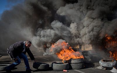 Workers of the Teva company protest against the company plan to lay off hundreds of employees, outside the TEVA Pharmaceutical Industries building in Jerusalem, December 17, 2017. (Noam Revkin Fenton/Flash90)