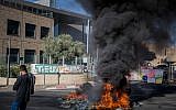 Workers of the Teva company protest against a plan to lay off hundreds of employees, outside the TEVA Pharmaceutical Industries building in Jerusalem, December 17, 2017. (Noam Revkin Fenton/Flash90)