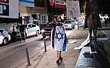 Israelis prepare for the weekly protest against the corruption of the government in Tel Aviv on December 30, 2017. (Tomer Neuberg/Flash90)