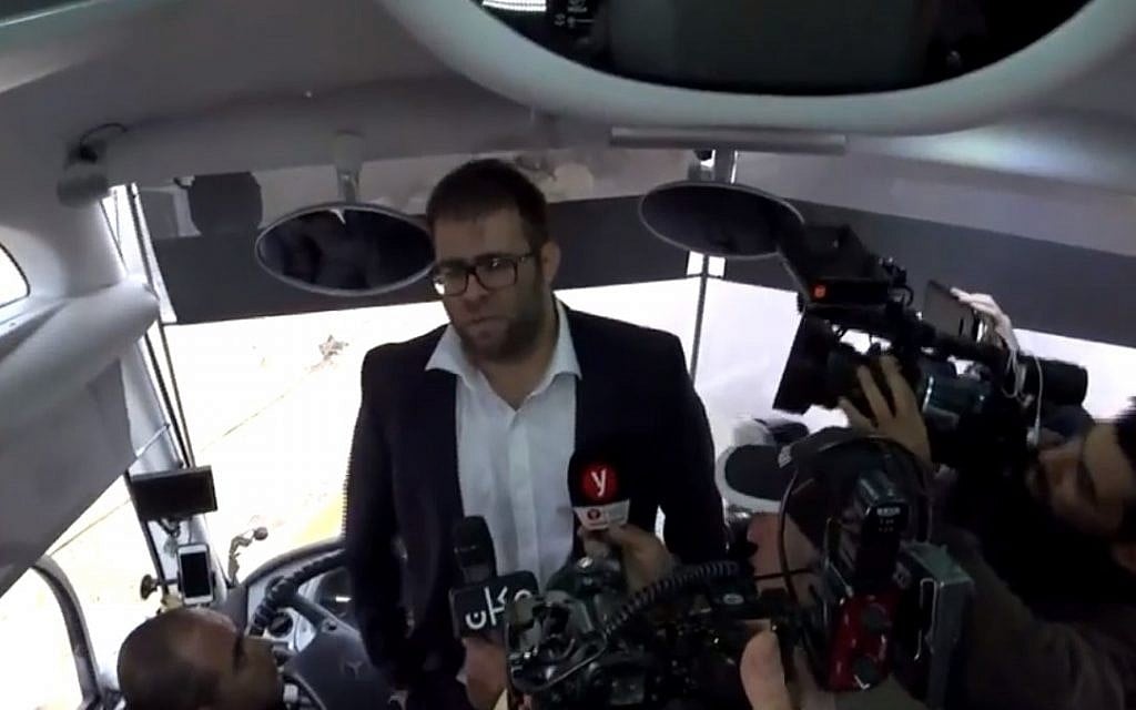 Likud MK Oren Hazan boards a bus carrying family members of Gazans being held in Israeli military prison, December 25, 2017. (Screen capture: Israel Hayom)