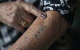 Illustrative: A Holocaust survivor shows her number tattoo. (Christopher Furlong/Getty Images via JTA)