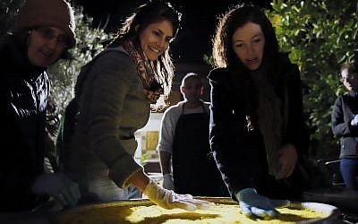 Making knafe, a traditional Palestinian dessert, on Sunday, December 3, 2017, in Beit Hanina, an Arab neighborhood of Jerusalem, as part of Open Holidays, a new event geared at understanding one anothers' traditions (Courtesy Open Holidays)