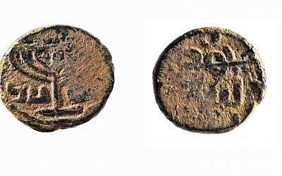 Umayyad coin (after the reform) with a seven-branched menorah model. Made of bronze. These coins were probably minted in Jerusalem around the 8th century CE. On one side of the coin is a seven-branched menorah with an inscription in Arabic: "There is no God but Allah." On the other side of the coin is an Arabic inscription, "Muhammad, the messenger of God," and above it is the symbol of the Muslim crescent. (Gift from the Abraham Sofer and Marianne Schweer Sofer Collection, Palo Alto, to American Friends of the Israel Museum, Jerusalem, Israel. © The Israel Museum, Jerusalem; Vladimir Nikhin)