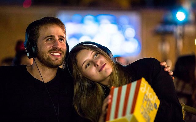 Moviegoers wearing earphones at a Muvix event in Tel Aviv. (Shahaf Haber)