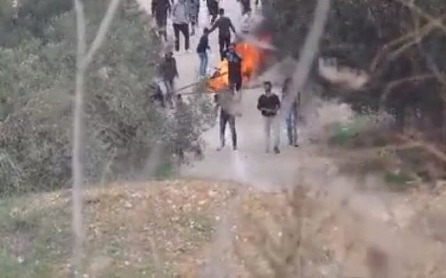 Video said to show Palestinians hurling rocks during a clash with settlers outside the northern West Bank village of Burin. (screen capture) Video said to show Palestinians hurling rocks during a clash with settlers outside the northern West Bank village of Burin. (screen capture)