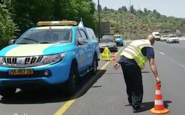 A driver of one of Netivei Israel's new mobile units places a traffic cone on a highway in Israel. (Screen capture: Channel 2) A driver of one of Netivei Israel's new mobile units places a traffic cone on a highway in Israel. (Screen capture: Channel 2)