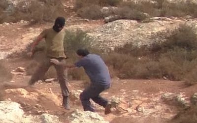 An Israeli settler assaults rabbi-activist Arik Ascherman who was accompanying a group of Palestinian farmers to their fields near Nablus on October 23, 2015. (Screen capture/ YouTube) An Israeli settler assaults rabbi-activist Arik Ascherman who was accompanying a group of Palestinian farmers to their fields near Nablus on October 23, 2015. (Screen capture/ YouTube)